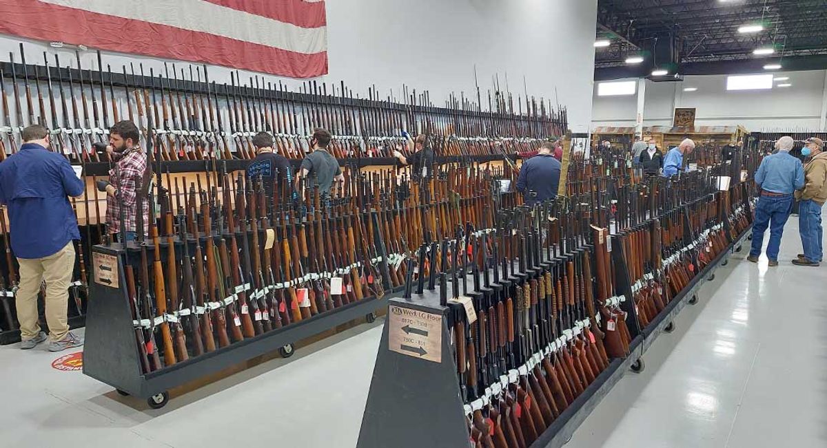 guns at a gun show for gun show collectors, gun collectors viewing guns