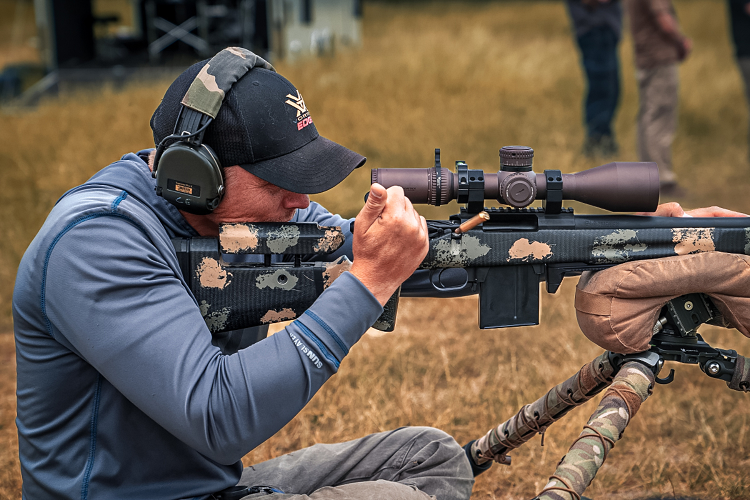 a man wearing gear for shooting sports whilst he is shooting