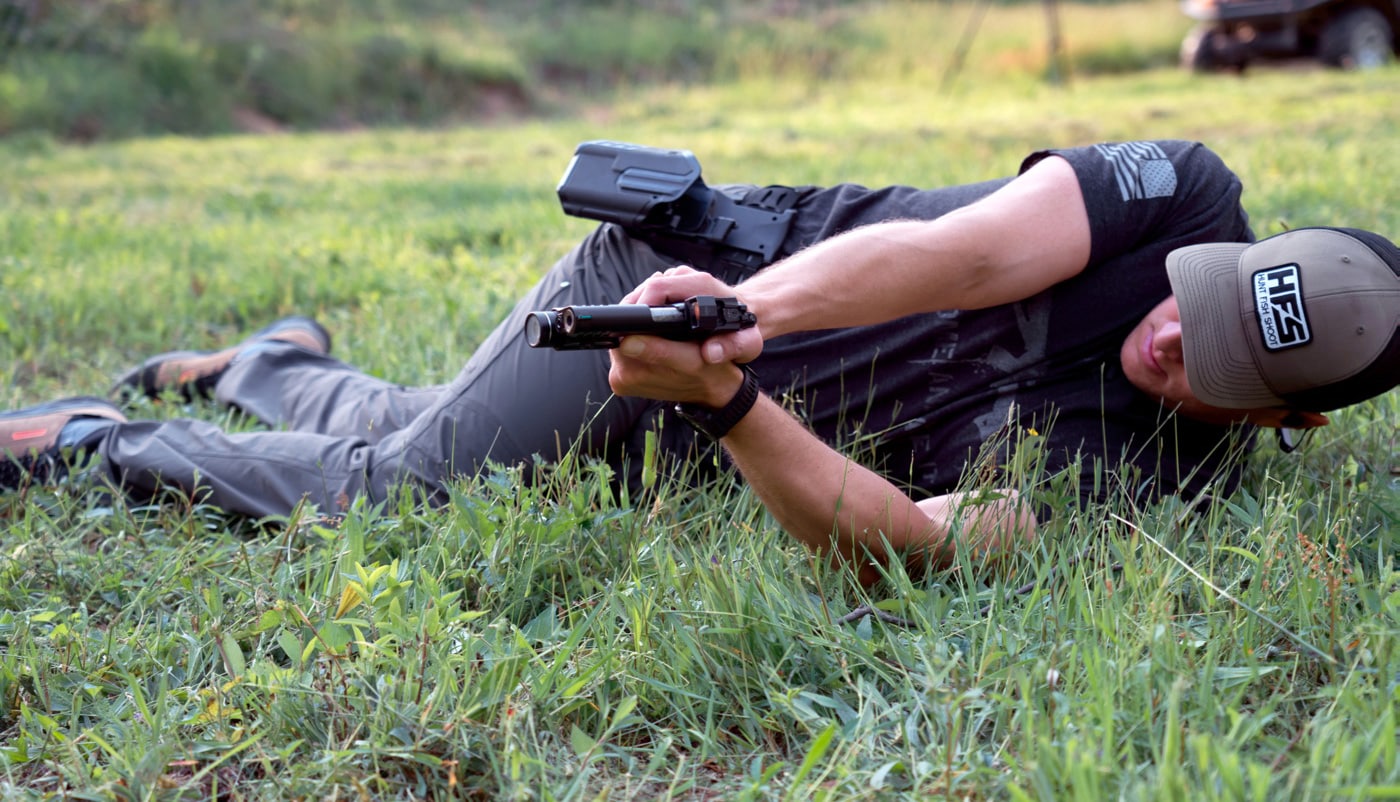 a lady laying on a green lawn showing best shooting techniques