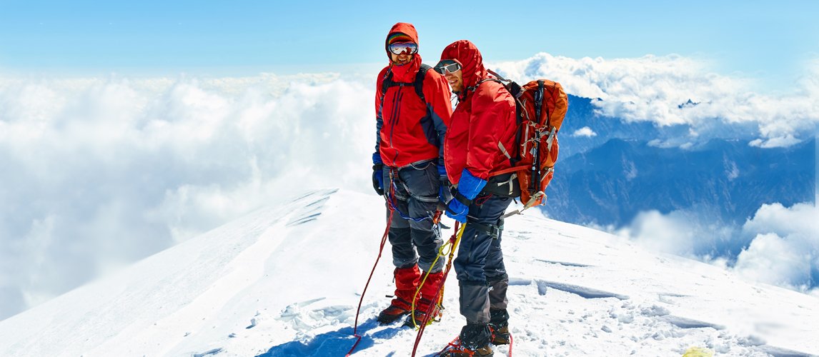two man wearing survival gear for extreme weather